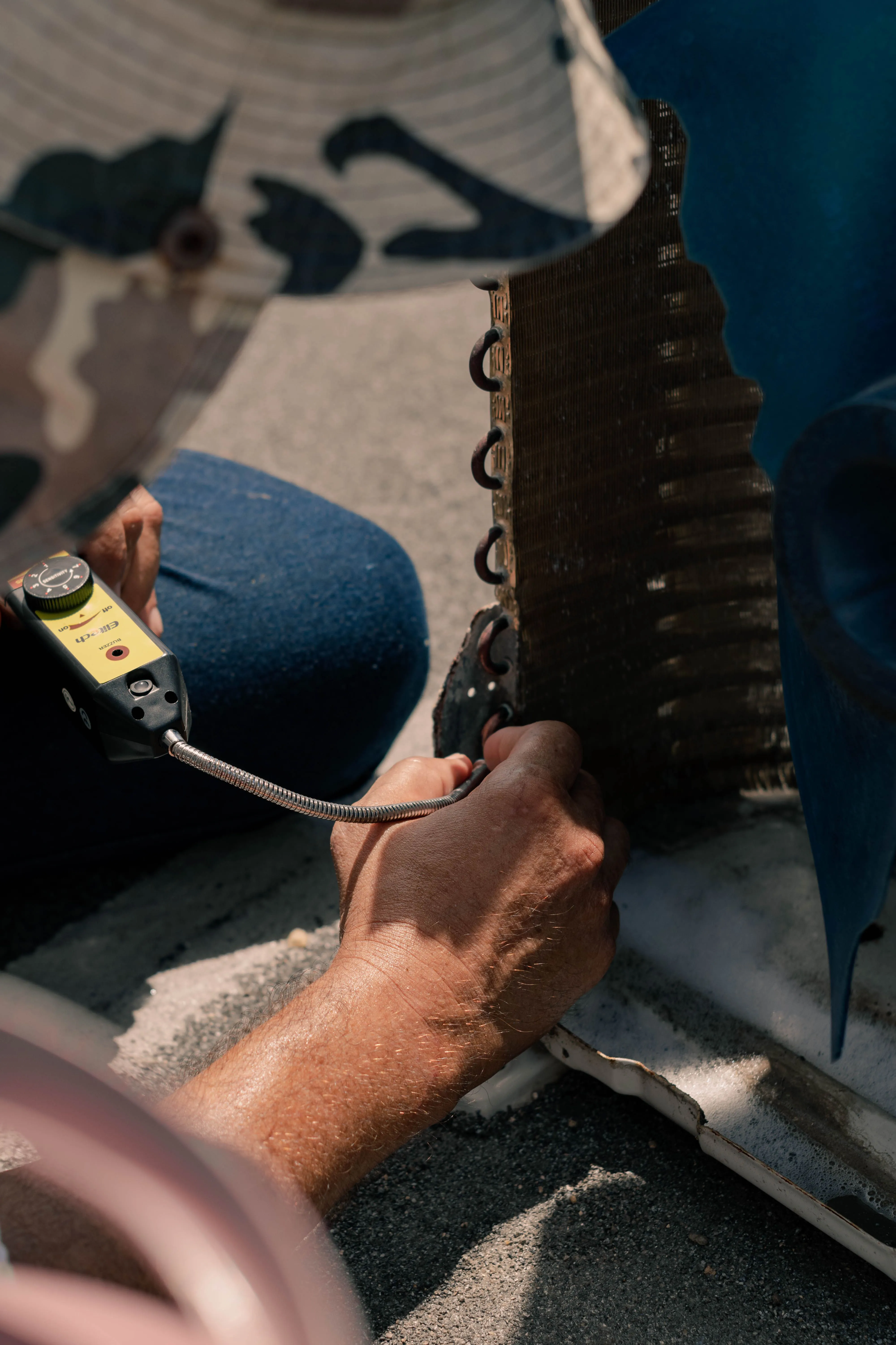 HVAC technician repairing an air conditioning unit